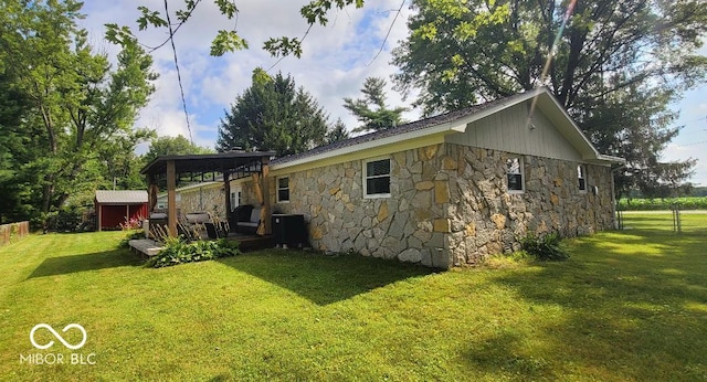 6974 S County Road 400 E, Clayton, IN 46118 - view of home's exterior featuring stone siding, a shed, and a gazebo
