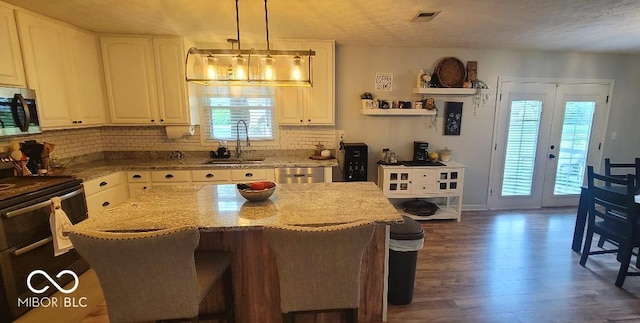 6974 S County Road 400 E, Clayton, IN 46118 - kitchen with stainless steel appliances, light stone counters, backsplash, white cabinetry, and dark wood-style flooring