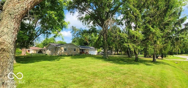 6974 S County Road 400 E, Clayton, IN 46118 - view of green lawn featuring a garage