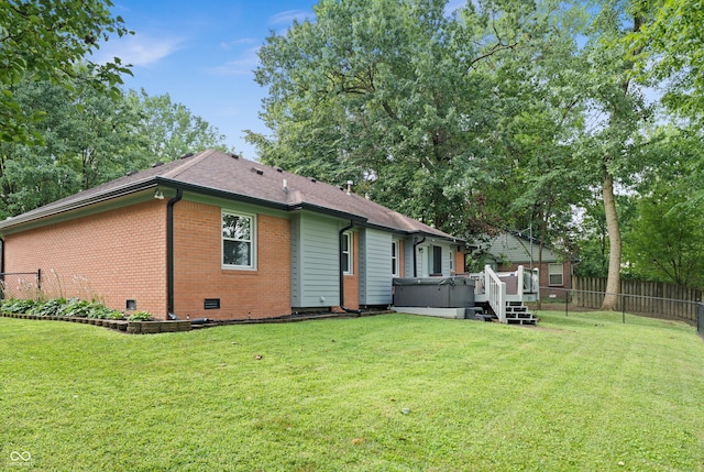 456 Old Hickory Ln, Greenwood, IN 46142 - back of house featuring a hot tub, brick siding, and a wooden deck