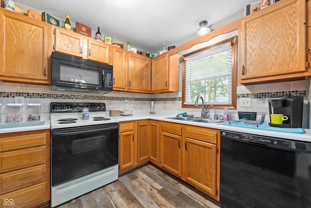 456 Old Hickory Ln, Greenwood, IN 46142 - kitchen with black appliances, light countertops, dark wood finished floors, and tasteful backsplash