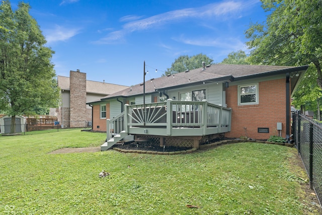 456 Old Hickory Ln, Greenwood, IN 46142 - rear view of house with a fenced backyard, a deck, brick siding, a chimney, and a storage unit