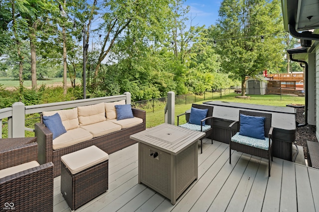 456 Old Hickory Ln, Greenwood, IN 46142 - wooden deck featuring outdoor lounge area, a storage unit, a fenced backyard, and view of wooded area