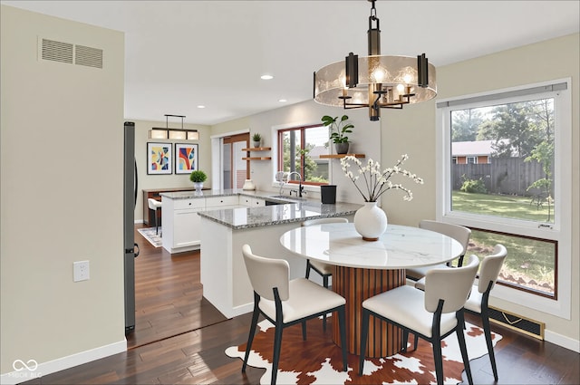 1441 Hunter Pl, Columbus, IN 47203 - dining room with dark wood-style flooring, a chandelier, and recessed lighting