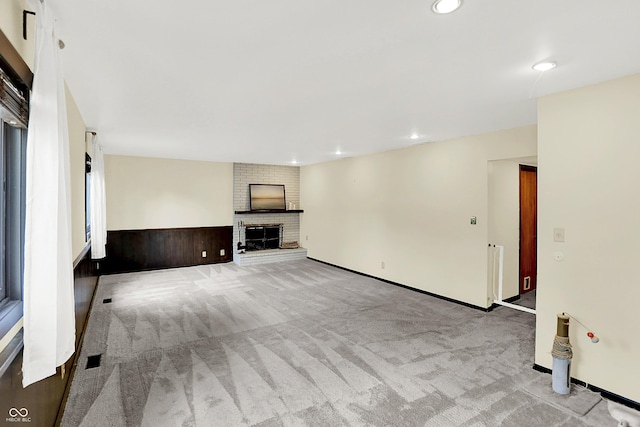 1441 Hunter Pl, Columbus, IN 47203 - unfurnished living room featuring a fireplace, carpet flooring, and recessed lighting