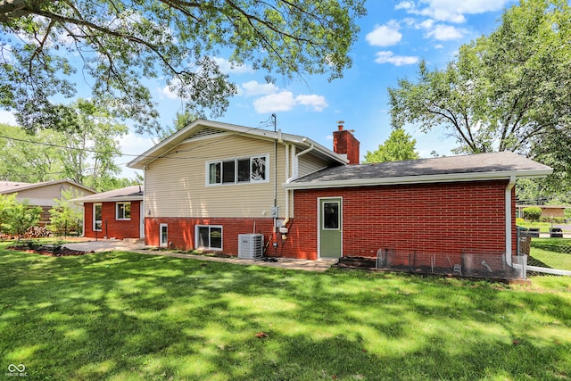 1441 Hunter Pl, Columbus, IN 47203 - rear view of house featuring a chimney, brick siding, and a patio