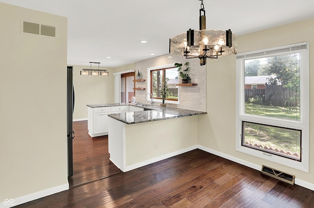 1441 Hunter Pl, Columbus, IN 47203 - kitchen with a peninsula, open shelves, a chandelier, white cabinetry, and stone counters