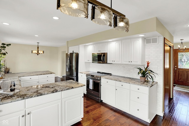 1441 Hunter Pl, Columbus, IN 47203 - kitchen featuring stainless steel appliances, a chandelier, backsplash, light stone countertops, and recessed lighting