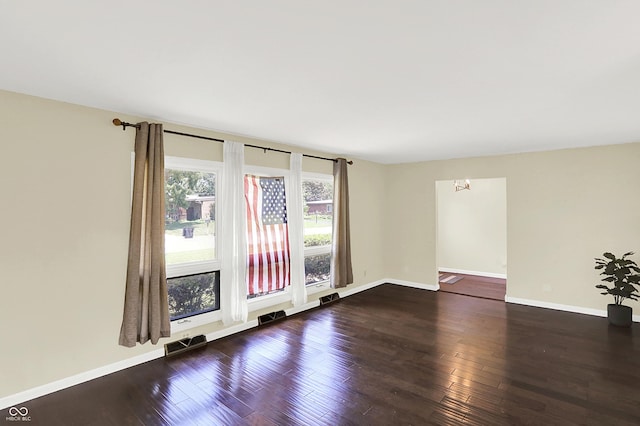 1441 Hunter Pl, Columbus, IN 47203 - spare room featuring baseboards and dark wood-style floors