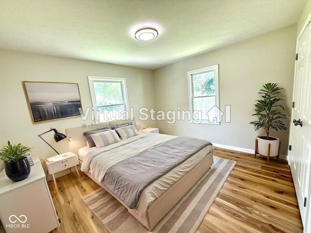 1809 Beam Rd, Columbus, IN 47201 - bedroom featuring light wood-type flooring and a textured ceiling