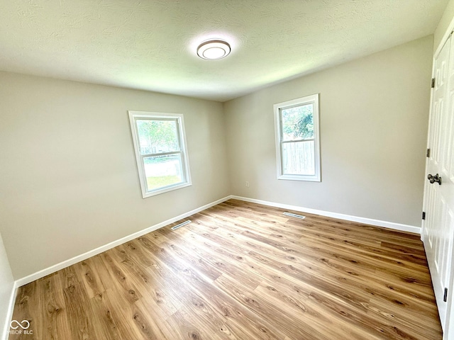 1809 Beam Rd, Columbus, IN 47201 - unfurnished room featuring wood finished floors and a textured ceiling