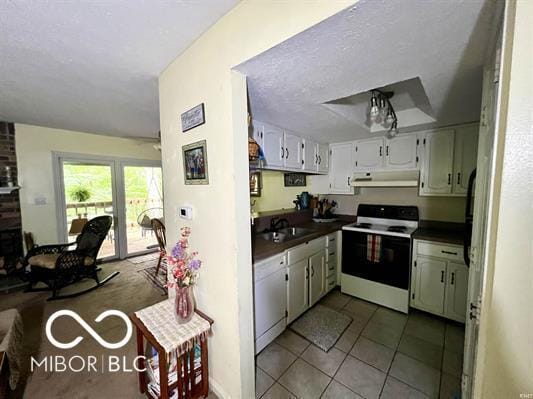 9406 S Lake Ridge Dr, Bloomington, IN 47401 - kitchen featuring white appliances, under cabinet range hood, dark countertops, and tile patterned floors