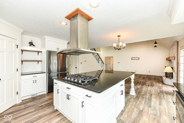 6413 Amber Pass, Plainfield, IN 46168 - kitchen featuring dark countertops, appliances with stainless steel finishes, light wood-style flooring, open shelves, and a textured ceiling