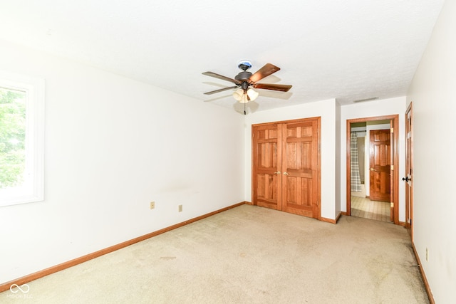 6413 Amber Pass, Plainfield, IN 46168 - unfurnished bedroom featuring light carpet, a closet, and a ceiling fan