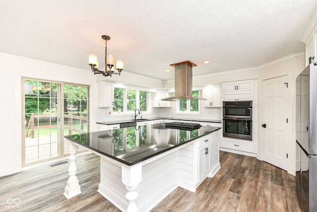 6413 Amber Pass, Plainfield, IN 46168 - kitchen featuring island exhaust hood, dark countertops, white cabinets, stainless steel appliances, and a chandelier