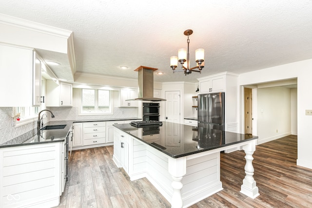 6413 Amber Pass, Plainfield, IN 46168 - kitchen featuring a kitchen island, freestanding refrigerator, island exhaust hood, white cabinets, and tasteful backsplash