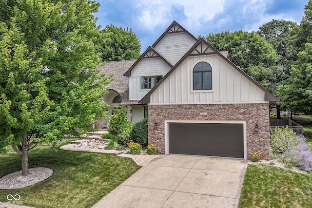 6413 Amber Pass, Plainfield, IN 46168 - view of front of property featuring board and batten siding, an attached garage, concrete driveway, a front lawn, and brick siding