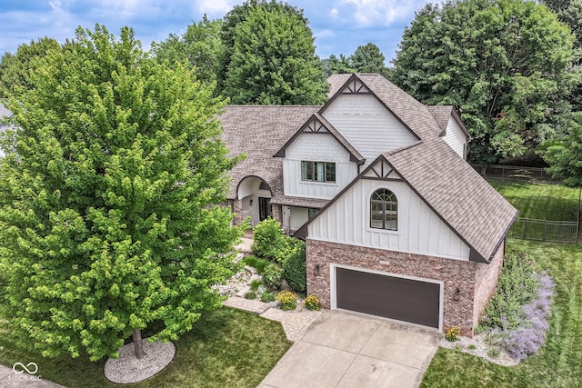 6413 Amber Pass, Plainfield, IN 46168 - view of front of house with board and batten siding, a garage, roof with shingles, and concrete driveway