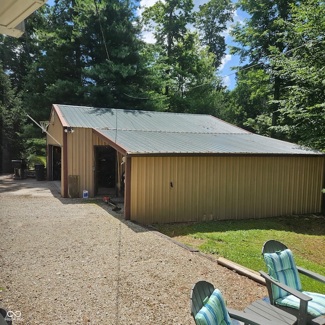 681 Hancock School Rd, Spencer, IN 47460 - view of outbuilding with gravel driveway and view of scattered trees