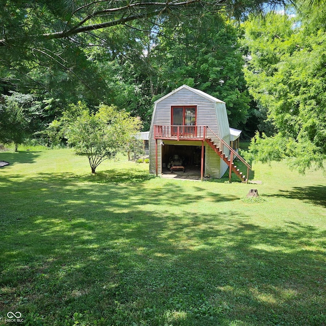 681 Hancock School Rd, Spencer, IN 47460 - view of green lawn with stairway, a garage, an outdoor structure, and a wooden deck