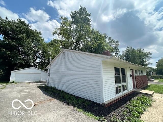 4463 N Bolton Ave, Indianapolis, IN 46226 - view of property exterior with an outbuilding and a detached garage