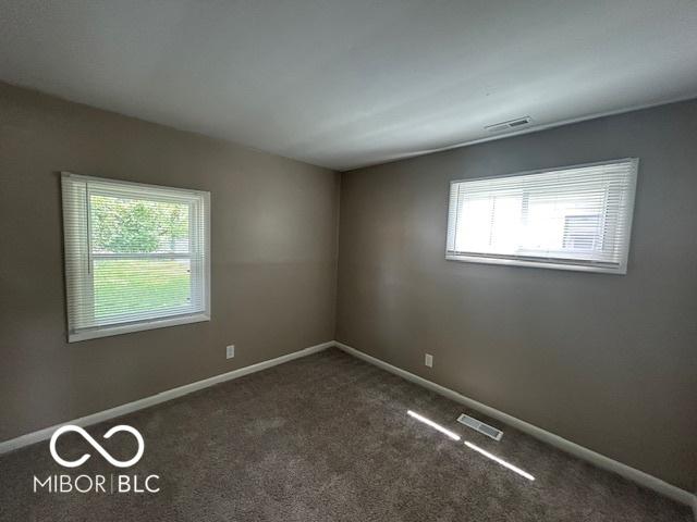 4463 N Bolton Ave, Indianapolis, IN 46226 - spare room with carpet floors and baseboards