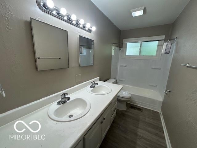 4463 N Bolton Ave, Indianapolis, IN 46226 - bathroom with double vanity, bathing tub / shower combination, and wood finished floors