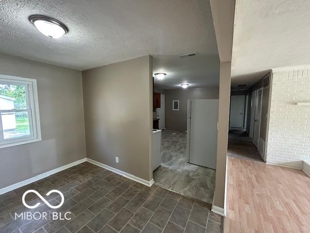 4463 N Bolton Ave, Indianapolis, IN 46226 - empty room with a textured ceiling and baseboards