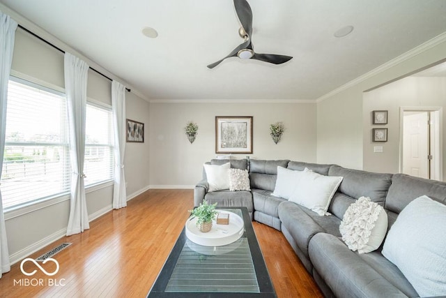 7929 W Bristol Way, New Palestine, IN 46163 - living area with light wood finished floors, a ceiling fan, and crown molding