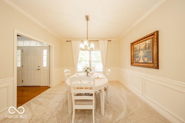7929 W Bristol Way, New Palestine, IN 46163 - dining space with carpet floors, a chandelier, a decorative wall, ornamental molding, and wainscoting