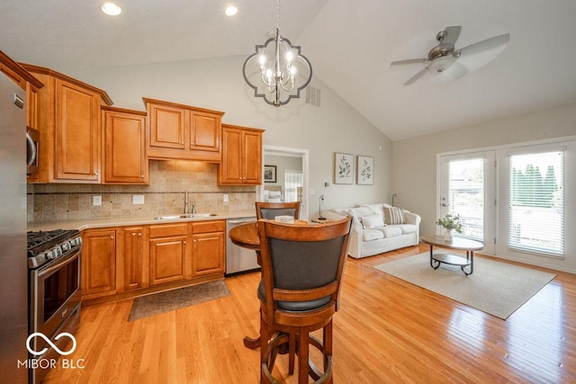 7929 W Bristol Way, New Palestine, IN 46163 - kitchen with stainless steel appliances, light countertops, high vaulted ceiling, ceiling fan, and light wood-style floors