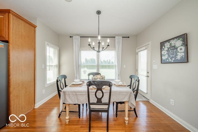 7929 W Bristol Way, New Palestine, IN 46163 - dining space featuring light wood-style flooring and a chandelier