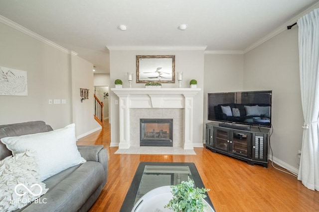 7929 W Bristol Way, New Palestine, IN 46163 - living area with wood finished floors, ornamental molding, a tile fireplace, and recessed lighting