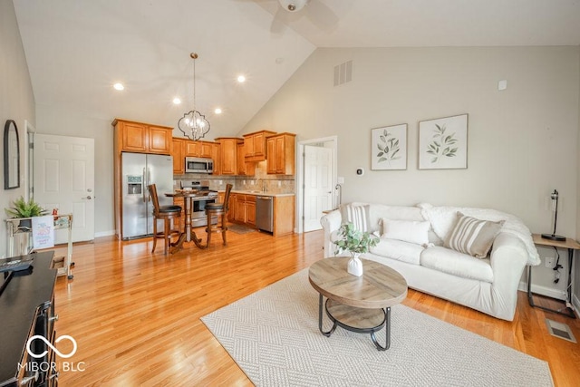 7929 W Bristol Way, New Palestine, IN 46163 - living area with a ceiling fan, high vaulted ceiling, light wood-type flooring, and recessed lighting
