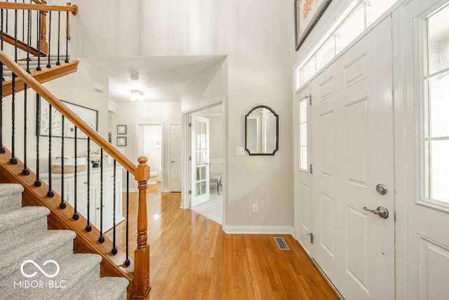 7929 W Bristol Way, New Palestine, IN 46163 - foyer entrance with stairs, light wood-type flooring, and a towering ceiling