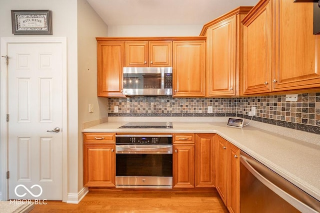 7929 W Bristol Way, New Palestine, IN 46163 - kitchen with stainless steel appliances, light wood finished floors, tasteful backsplash, and light countertops