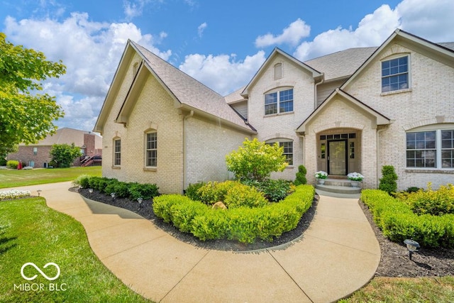 7929 W Bristol Way, New Palestine, IN 46163 - view of front facade with brick siding, roof with shingles, and a front lawn
