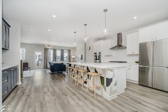 9732 Junction, Fishers, IN 46037 - kitchen featuring appliances with stainless steel finishes, open floor plan, light wood finished floors, wall chimney exhaust hood, and light countertops
