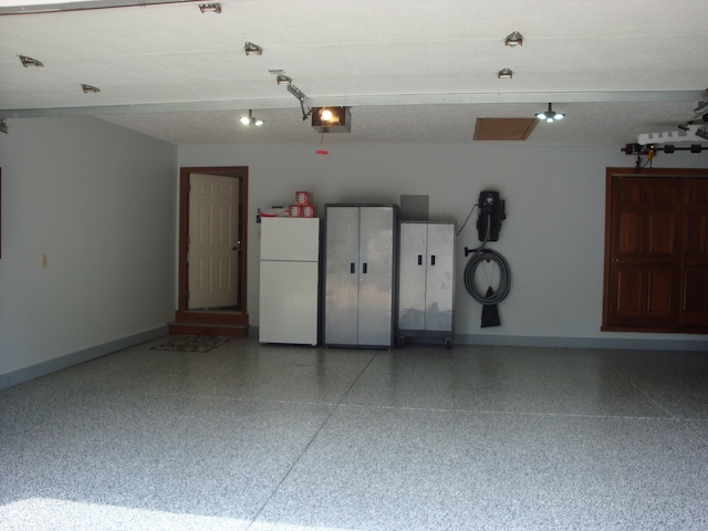 7839 Jessica Ct, Avon, IN 46123 - garage with a garage door opener and freestanding refrigerator