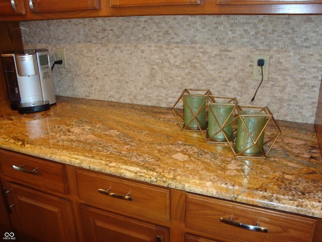 7839 Jessica Ct, Avon, IN 46123 - kitchen featuring brown cabinetry, light stone countertops, and decorative backsplash