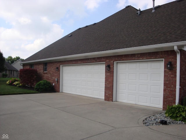 7839 Jessica Ct, Avon, IN 46123 - view of side of property with brick siding, roof with shingles, concrete driveway, and an attached garage