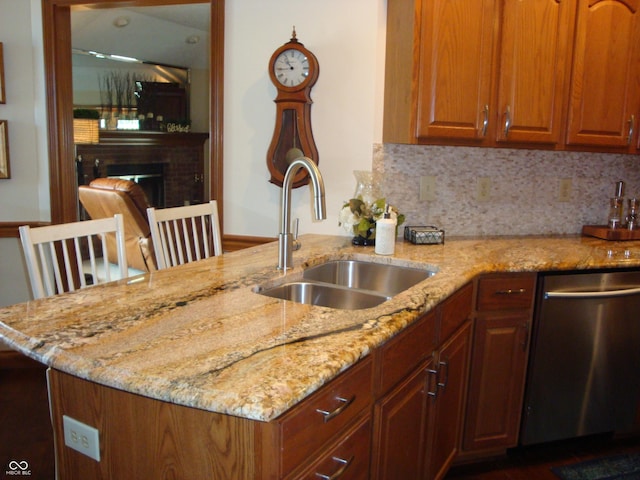 7839 Jessica Ct, Avon, IN 46123 - kitchen with stainless steel dishwasher, light stone counters, a peninsula, decorative backsplash, and a fireplace