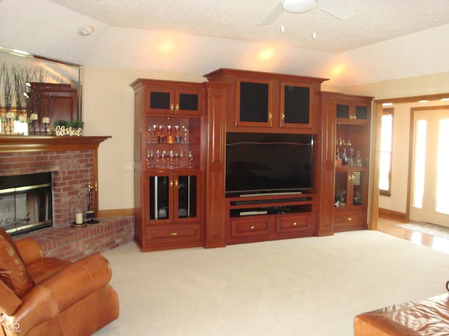 7839 Jessica Ct, Avon, IN 46123 - living room featuring vaulted ceiling, carpet flooring, a ceiling fan, and a brick fireplace