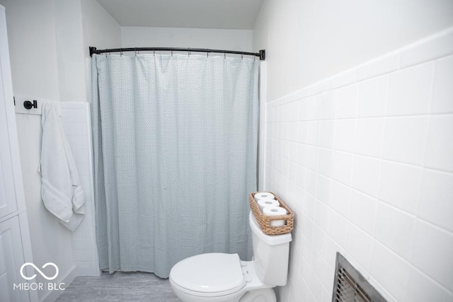 8310 N County Road 700 W, Scipio, IN 47273 - bathroom with tile walls, wood finished floors, and a shower with curtain