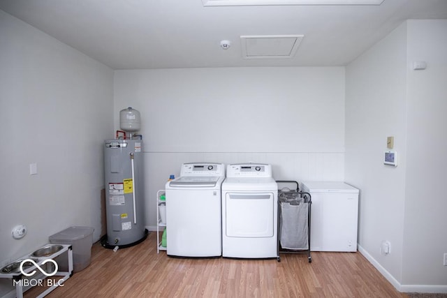 8310 N County Road 700 W, Scipio, IN 47273 - laundry room with washer and clothes dryer, wood finished floors, electric water heater, and attic access