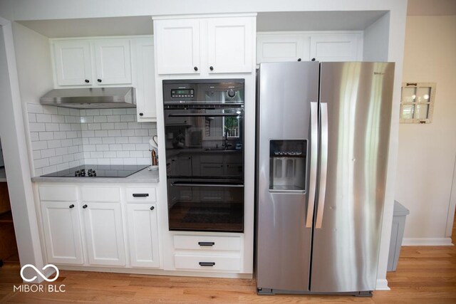 8310 N County Road 700 W, Scipio, IN 47273 - kitchen featuring black appliances, tasteful backsplash, and white cabinetry