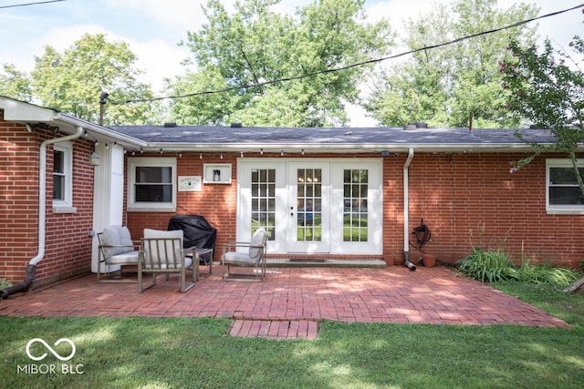 8310 N County Road 700 W, Scipio, IN 47273 - back of property with french doors, a patio area, brick siding, and a lawn