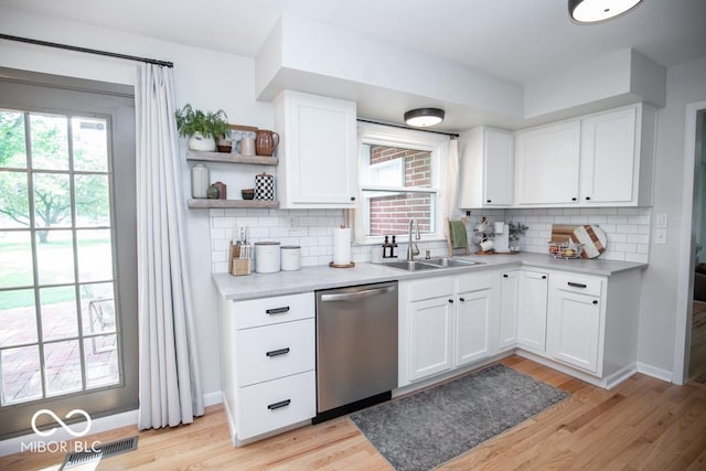 8310 N County Road 700 W, Scipio, IN 47273 - kitchen with stainless steel dishwasher, backsplash, healthy amount of natural light, and light countertops