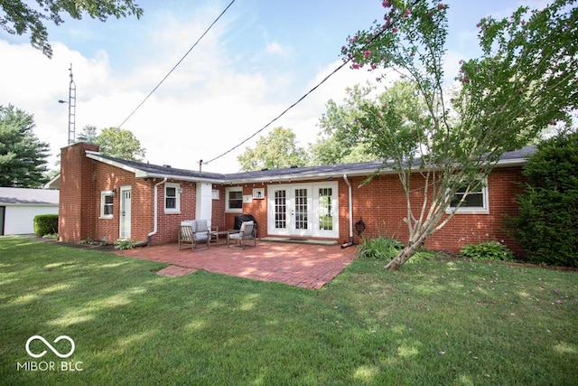 8310 N County Road 700 W, Scipio, IN 47273 - rear view of property with french doors, a lawn, a patio area, brick siding, and a chimney