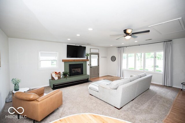 8310 N County Road 700 W, Scipio, IN 47273 - living room featuring plenty of natural light, wood finished floors, ceiling fan, recessed lighting, and a fireplace with raised hearth